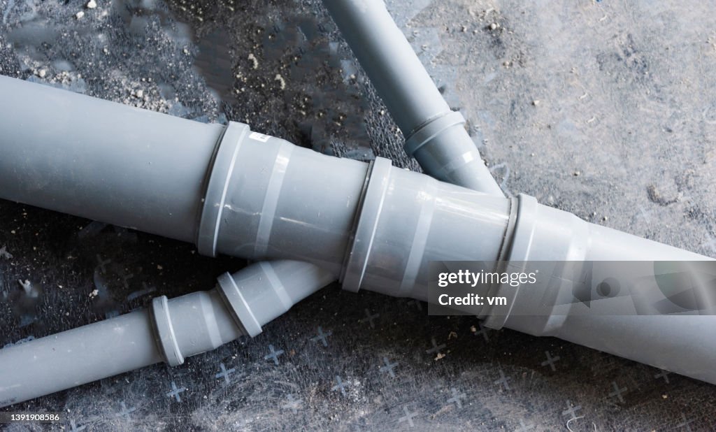 Drain piping, grey plastic pipes various diameters connecting into one