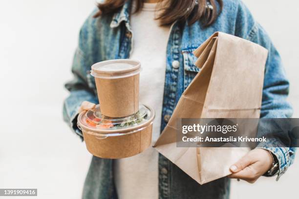 female customer buying takeaway coffee and food in craft packages. - salad bowl stock pictures, royalty-free photos & images