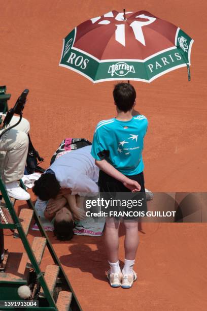 Serbian player Jelena Jankovic gets medical assistance during a match break with Polish player Agnieszka Radwanska during the fourth round of the...