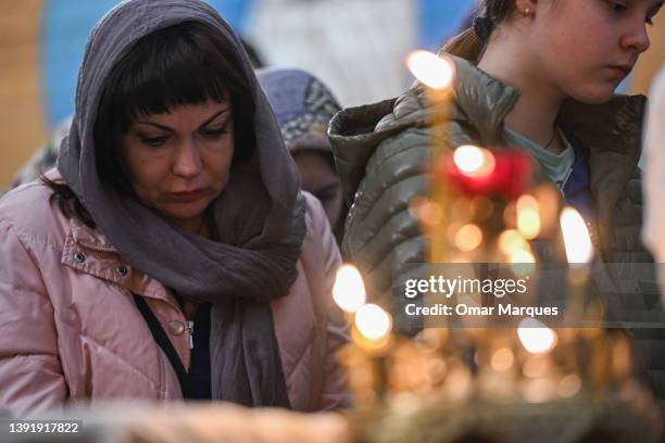 People who fled the war in Ukraine and members of the Ukrainian diaspora take part in the Palm Sunday mass at the Orthodox church of the Assumption...