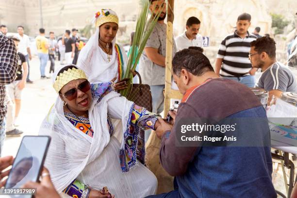 Coptic Christians celebrate Palm Sunday inside the St. Sama'ans Church on the Mokattam hills on April 17, 2022 in Cairo, Egypt. As Covid-19...