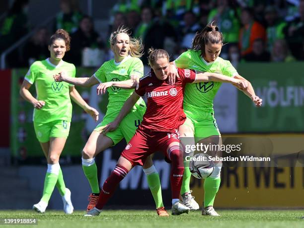 Kathrin-Julia Hendrich and Lena Oberdorf of VfL Wolfsburg battles for possession with Sydney Lohmann of FC Bayern Muenchen during the Women's DFB Cup...