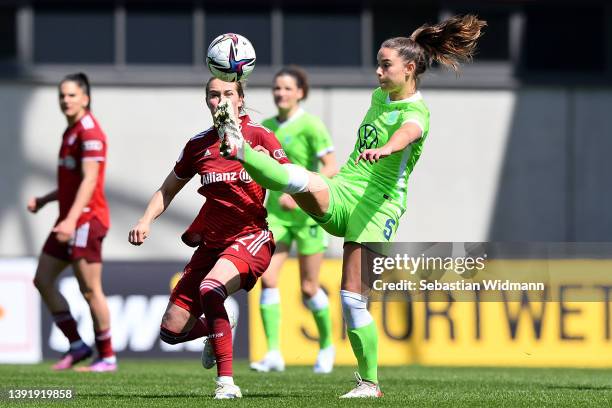 Sydney Lohmann of FC Bayern Muenchen is challenged by Lena Oberdorf of VfL Wolfsburg during the Women's DFB Cup semi final match between Bayern...