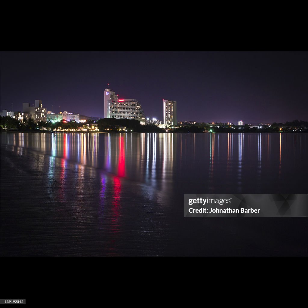 Building reflection in Tumon Bay at night