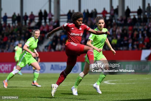 Lineth Beerensteyn of FC Bayern Muenchen is challenged by Dominique Janssen of VfL Wolfsburg during the Women's DFB Cup semi final match between...