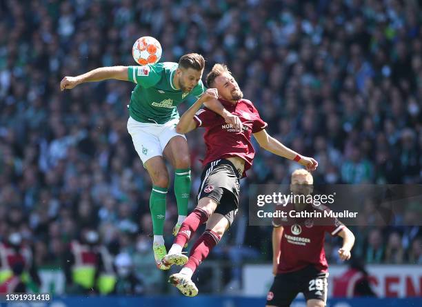 Niclas Fuellkrug of Werder Bremen and Florian Hübner of 1. FC Nuernberg battle for the ball during the Second Bundesliga match between SV Werder...