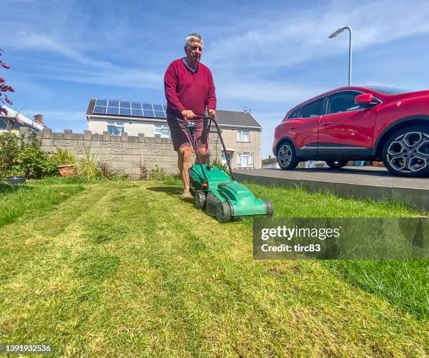 senior man mowing the lawn - mowed lawn stock pictures, royalty-free photos & images