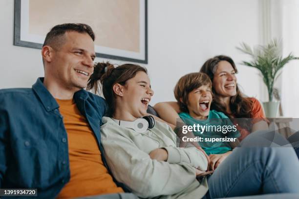 watching comedy movie - family watching television stock pictures, royalty-free photos & images