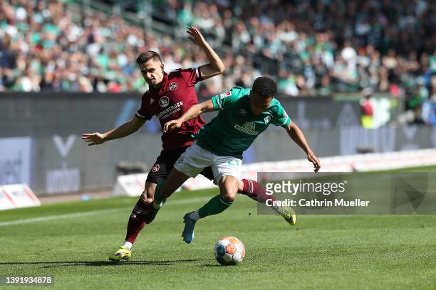 Felix Agu of Werder Bremen is challenged by Nikola Dovedan of 1. FC Nuernberg during the Second Bundesliga match between SV Werder Bremen and 1. FC...