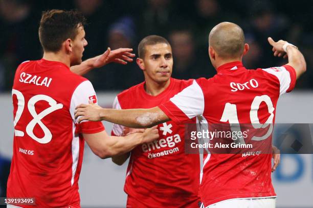 Mohamed Zidan of Mainz celebrates his team's first goal with team mates Adam Szalai and Elkin Soto during the Bundesliga match between 1899...