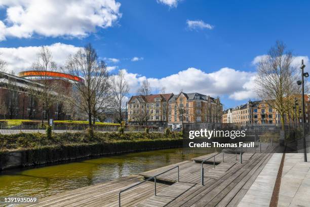 aros aarhus art museum with colourful walkway on top seen from a canal - aros aarhus stock pictures, royalty-free photos & images