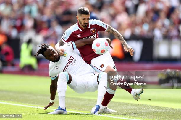 Manuel Lanzini of West Ham United is challenged by Maxwel Cornet of Burnley during the Premier League match between West Ham United and Burnley at...