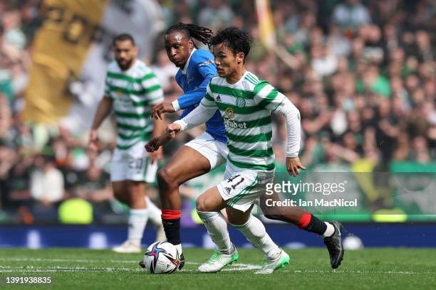 Reo Hatate of Celtic is challenged by Joe Aribo of Rangers during the Scottish Cup Semi Final match between Celtic FC and Rangers FC at Hampden Park...