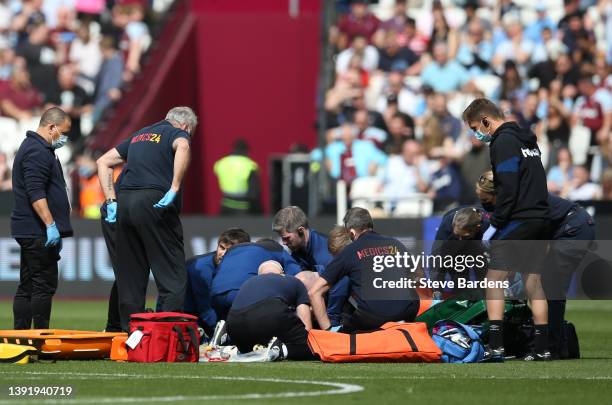 Ashley Westwood of Burnley receives medical attention while injured during the Premier League match between West Ham United and Burnley at London...