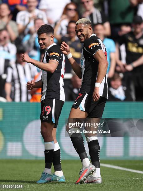 Bruno Guimaraes celebrates with teammate Joelinton of Newcastle United after scoring their team's first goal during the Premier League match between...