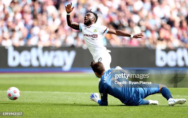 Maxwel Cornet of Burnley is tackled by Lukasz Fabianski of West Ham United leading to a penalty decision during the Premier League match between West...