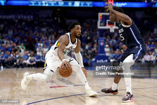 Donovan Mitchell of the Utah Jazz drives to the basket against Reggie Bullock of the Dallas Mavericks in the fourth quarter of Game One of the...