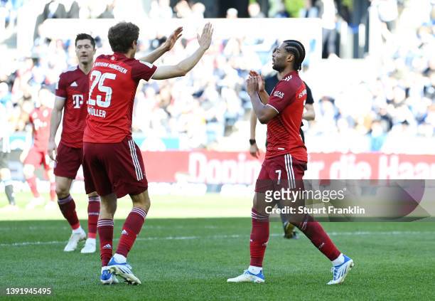 Serge Gnabry of FC Bayern Muenchen celebrates with team mate Thomas Mueller after scoring their sides second goal during the Bundesliga match between...