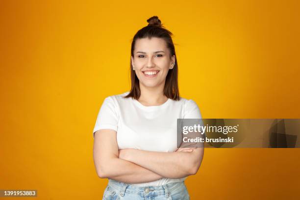 studio portrait of an attractive 24 year old woman - arms crossed stock pictures, royalty-free photos & images