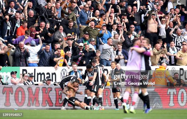 Bruno Guimaraes of Newcastle United celebrates with teammates after scoring their team's second goal during the Premier League match between...