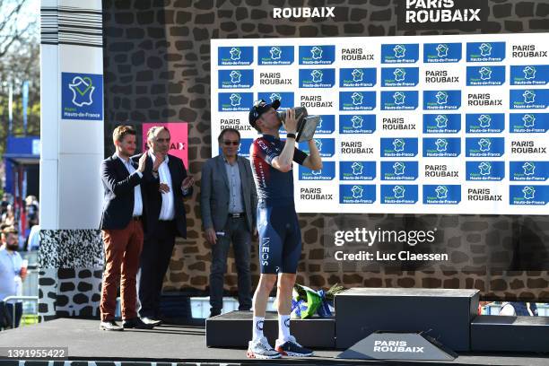 Dylan Van Baarle of Netherlands and Team INEOS Grenadiers celebrates winning the race and holds up the Cobbleston trophy on the podium ceremony after...