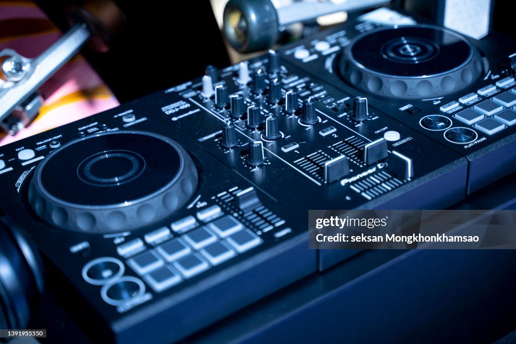 DJ Spinning, Mixing, and Scratching in a Night Club