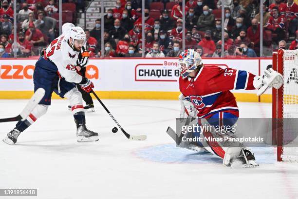 Tom Wilson of the Washington Capitals skates in alone with the puck against goaltender Sam Montembeault of the Montreal Canadiens during the first...