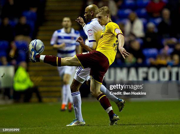 Ben Mee of Burnley clears the ball under pressure from Jimmy Kebe of Reading during the npower Championship match between Reading and Burnley at the...