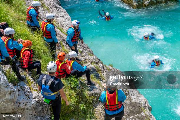 adrenaline adventure in mountain gorge, jumping from rock to cold water - life jacket stock pictures, royalty-free photos & images