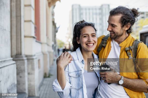 photo of couple walking in the city - spring city break stock pictures, royalty-free photos & images