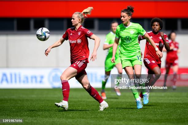 Lea Schüller of FC Bayern München and Felicitas Rauch of VfL Wolfsburg compete for the ball during the Women's DFB Cup semi final match between...