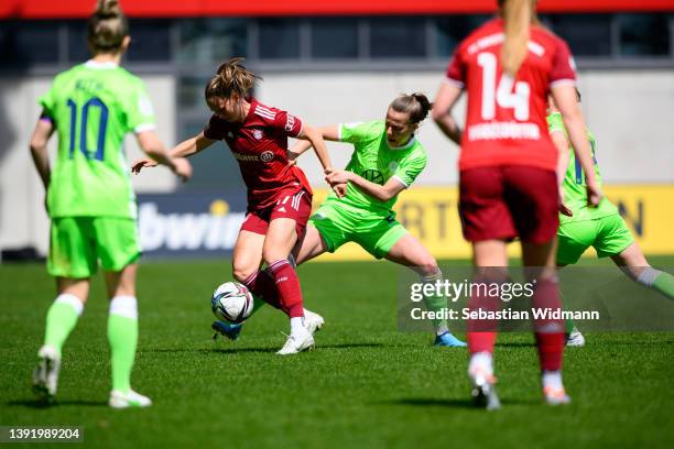 Klara Bühl of FC Bayern München and Lynn Wilms of VfL Wolfsburg compete for the ball during the Women's DFB Cup semi final match between Bayern...