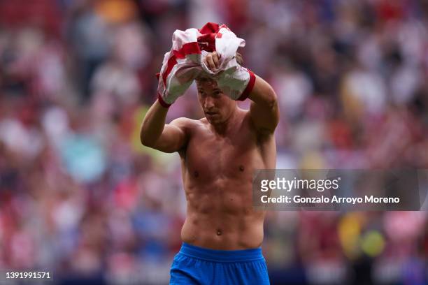 Marcos Llorente of Atletico de Madrid takes off his t-shirt as he acknowledges the audience after winning the LaLiga Santander match between Club...