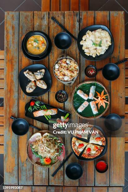 table full of dishes from east to west - vietnamese food stock pictures, royalty-free photos & images