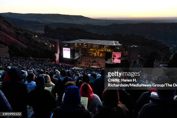 The sky starts to lighten as hundreds of people take part in the 75th annual Easter Sunrise service at Red Rocks Park and Amphitheatre on April 17,...