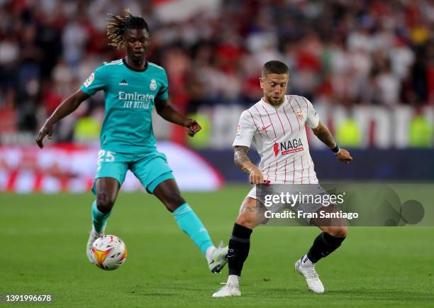 Alejandro Gomez of Sevilla FC battles for possession with Eduardo Camavinga of Real Madrid during the LaLiga Santander match between Sevilla FC and...