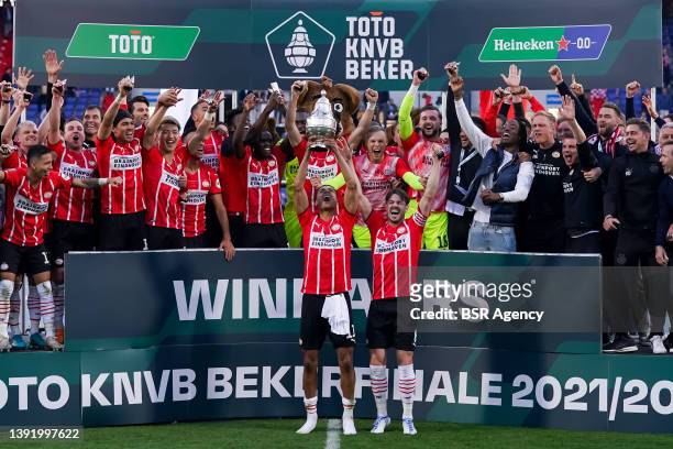Cody Gakpo of PSV and Marco van Ginkel of PSV receive the KNVB Cup from former PSV coach Guus Hiddink during the TOTO KNVB Cup Final match between...