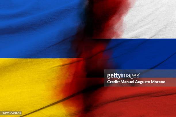 blood-stained flags of ukraine and russia - ukraine war bildbanksfoton och bilder