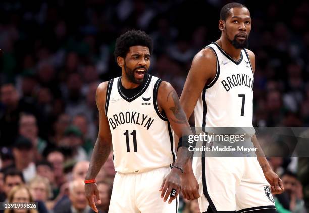 Kyrie Irving of the Brooklyn Nets and Kevin Durant look on during the first quarter of Round 1 Game 1 of the 2022 NBA Eastern Conference Playoffs...