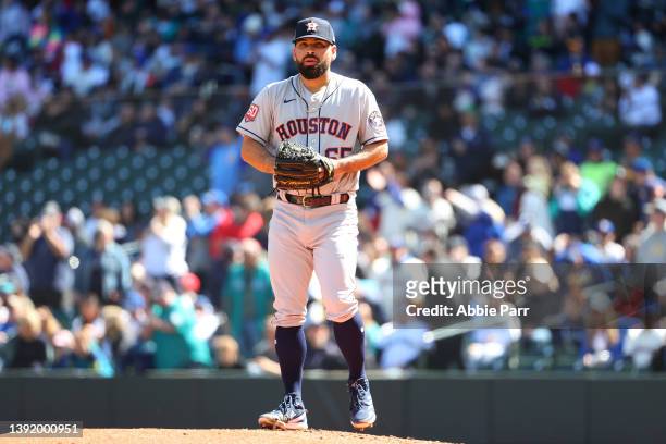 Jose Urquidy of the Houston Astros reacts after giving up a RBI single to Eugenio Suarez of the Seattle Mariners to take a 1-0 lead during the first...
