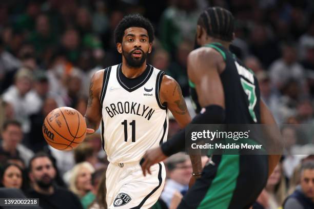 Kyrie Irving of the Brooklyn Nets dribbles downcourt against Jaylen Brown of the Boston Celtics during the first quarter of Round 1 Game 1 of the...