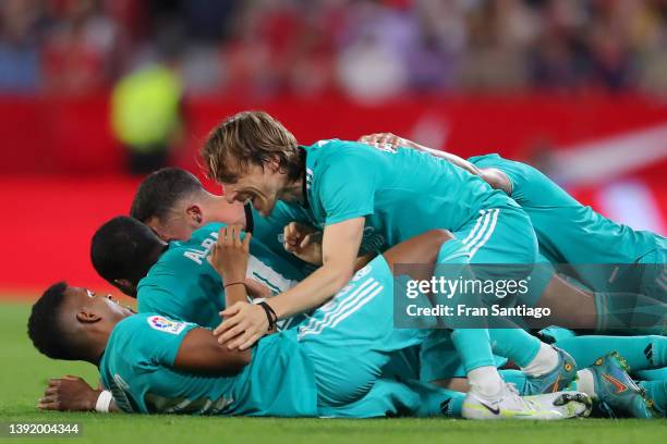 Karim Benzema of Real Madrid celebrates with his team after he scores their team's third goal during the LaLiga Santander match between Sevilla FC...