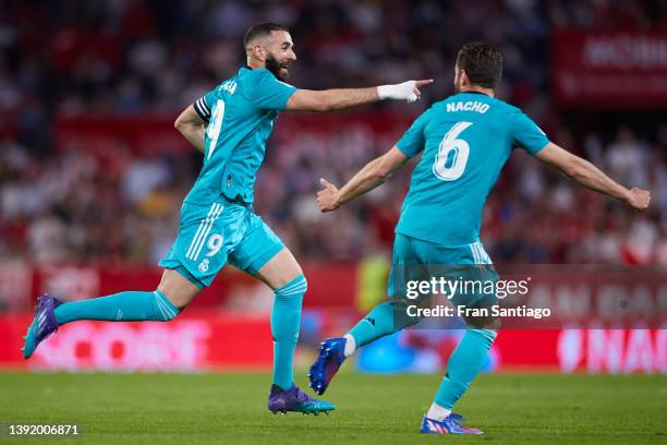 Karim Benzema of Real Madrid celebrates scoring his teams second goal with team mates during the LaLiga Santander match between Sevilla FC and Real...