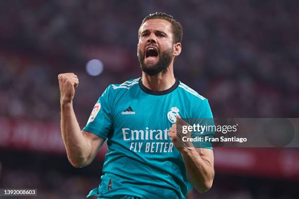 Nacho Fernandez of Real Madrid celebrates scoring his teams second goal with team mates during the LaLiga Santander match between Sevilla FC and Real...
