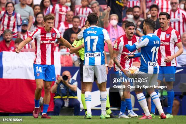 Marcos Llorente of Club Atletico de Madrid argue with Didac Vila of RCD Espanyol during the LaLiga Santander match between Club Atletico de Madrid...