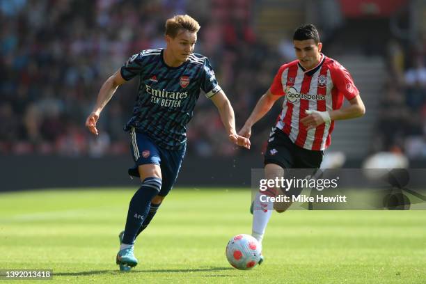 Martin Odegaard of Arsenal gets away from Mohamed Elyounoussi of Southampton during the Premier League match between Southampton and Arsenal at St...