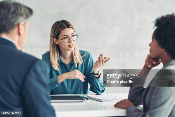 young businesswoman speaking on a meeting - small group of people stock pictures, royalty-free photos & images
