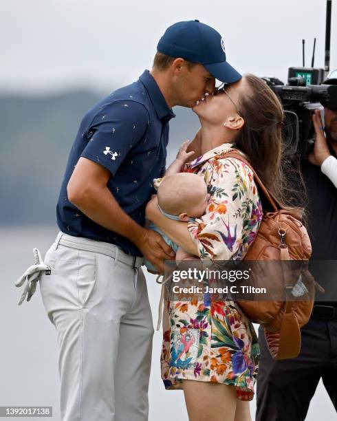 Jordan Spieth and wife Annie Verret celebrate with son Sammy on the 18th green after Spieth beat Patrick Cantlay in a playoff to win the RBC Heritage...