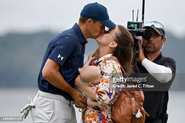 Jordan Spieth and wife Annie Verret celebrate with son Sammy on the 18th green after Spieth beat Patrick Cantlay in a playoff to win the RBC Heritage...