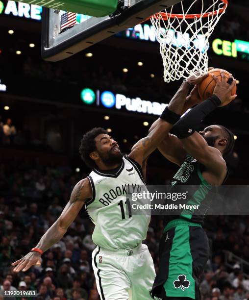 Jaylen Brown of the Boston Celtics takes a shot against Kyrie Irving of the Brooklyn Nets during the fourth quarter of Round 1 Game 1 of the 2022 NBA...